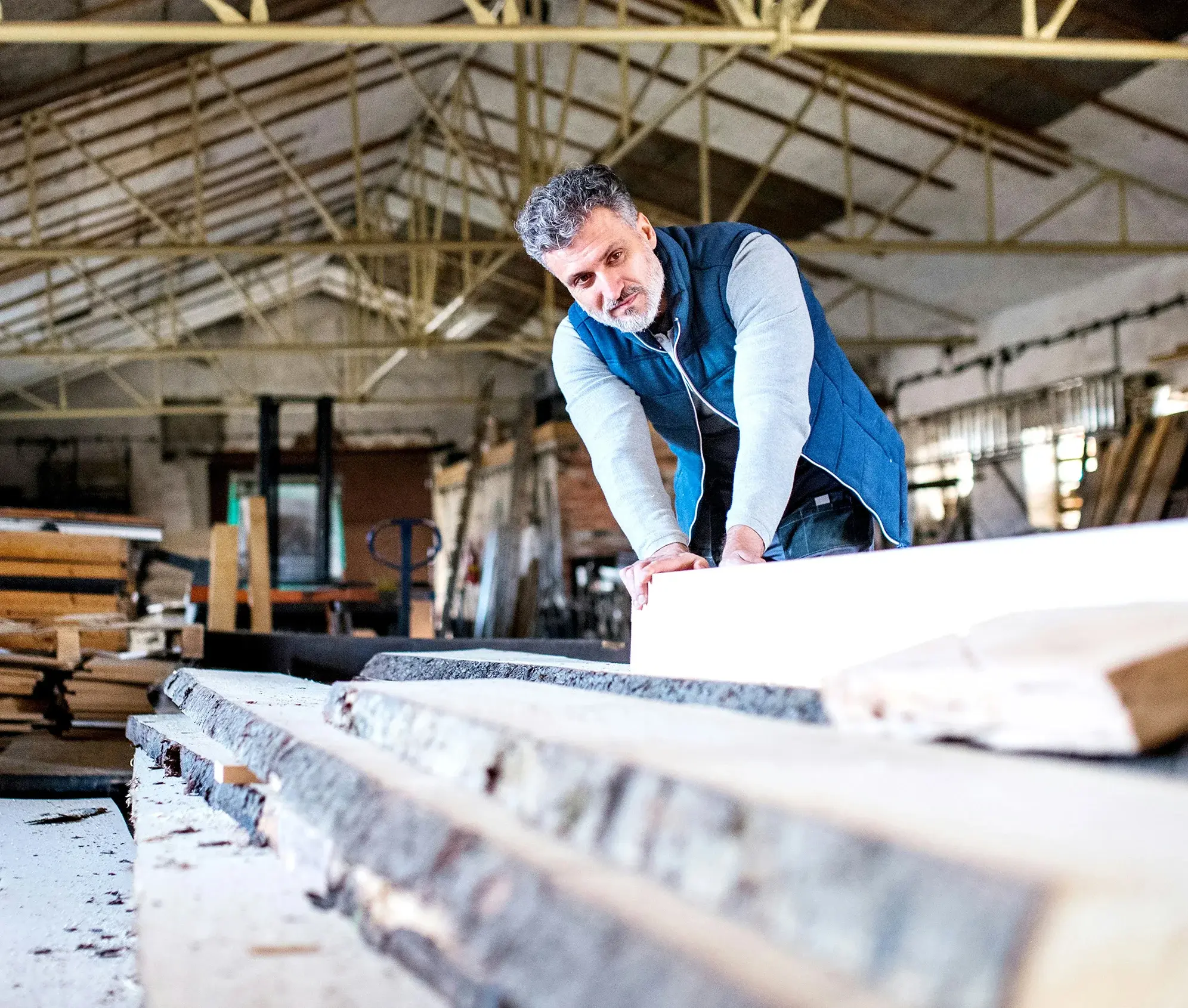 Stacks of kiln-dried lumber in warehouse setting